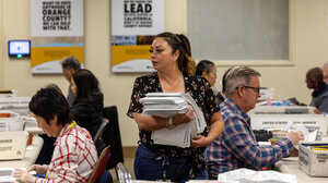 Election official holding stack of papers