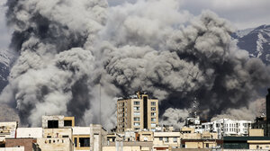 A bomb strike sends up a huge cloud of smoke in Teheran