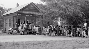 Historical image of Black voters in line at a polling place