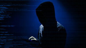 Hooded figure surrounded by lines of computer code