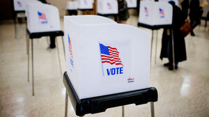 voting booth with United States flag on side