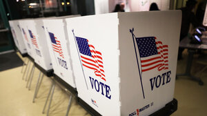 Voting booths with American flag