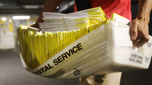 person carrying mail ballots 