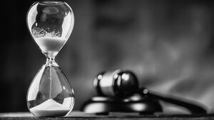 black and white image of hourglass and gavel