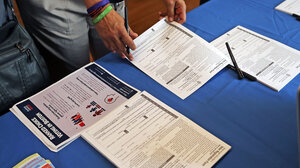 voter registration forms on table with blue tablecloth