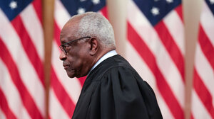 Clarence Thomas with American flags in background