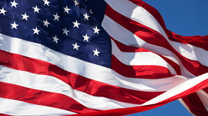 waving American flag against blue sky