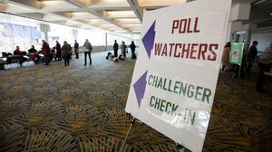 Poll watchers and challengers sign in at a polling site in Detroit. 