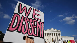 "We Dissent" poster in front of U.S. Supreme Court